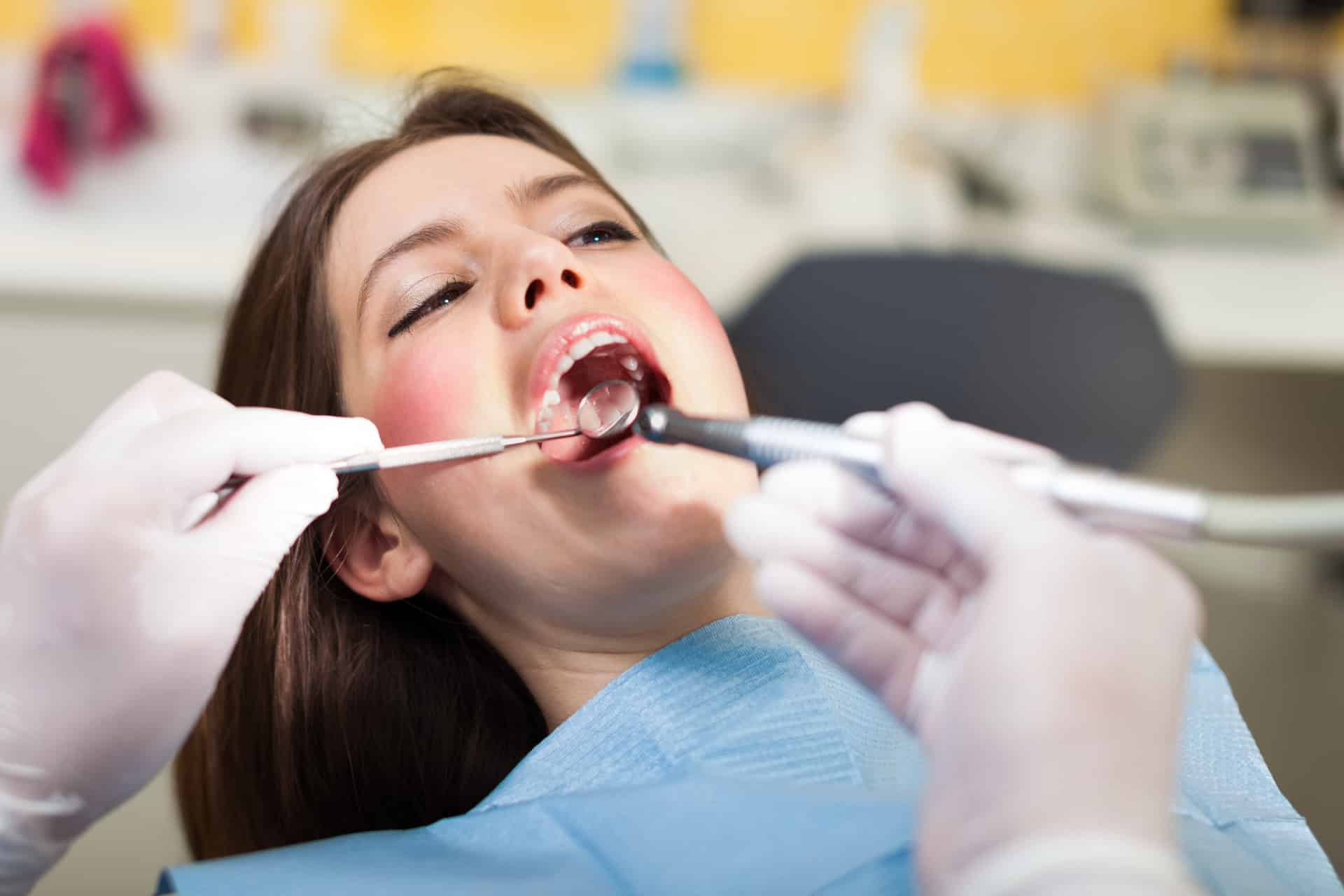 Woman in Grand Bay AL getting a denal exam to see if she should get dental veneers.